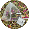 Pack of green tea bags infused with coconut pieces and rose petals